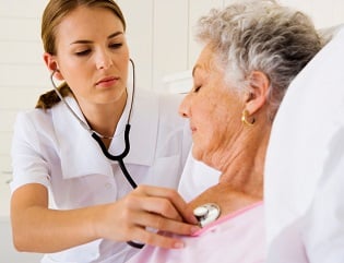 Nurse listening to elderly patient's heart and lungs Nurse listening to elderly patient's heart and lungs