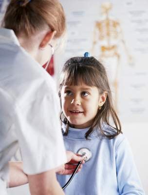 Nurse listening to a child's heart and lungs Nurse listening to a child's heart and lungs