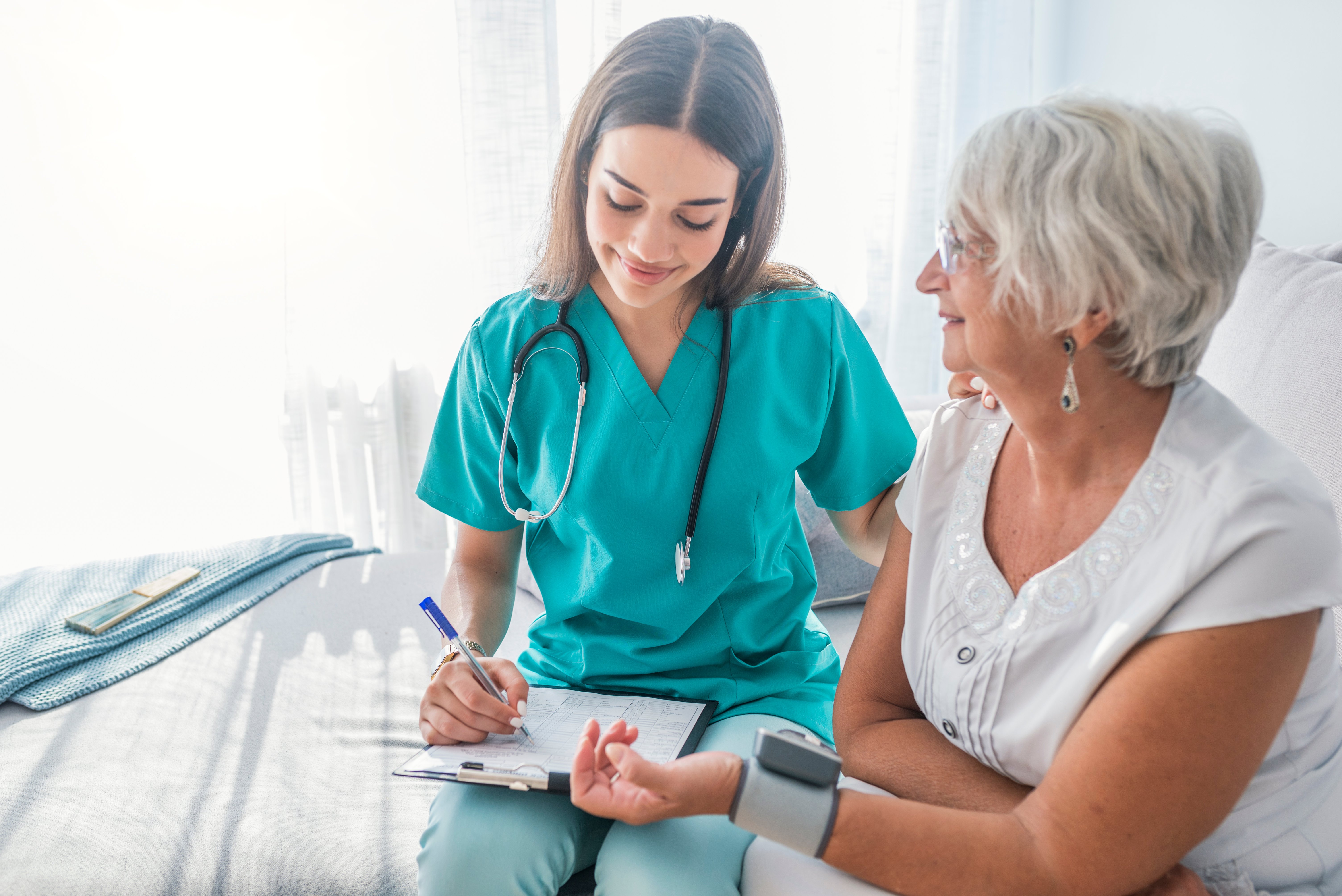 Nurse checking a patients blood pressure Nurse checking a patients blood pressure