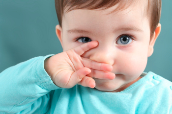 Infant wiping his nose Infant wiping his nose