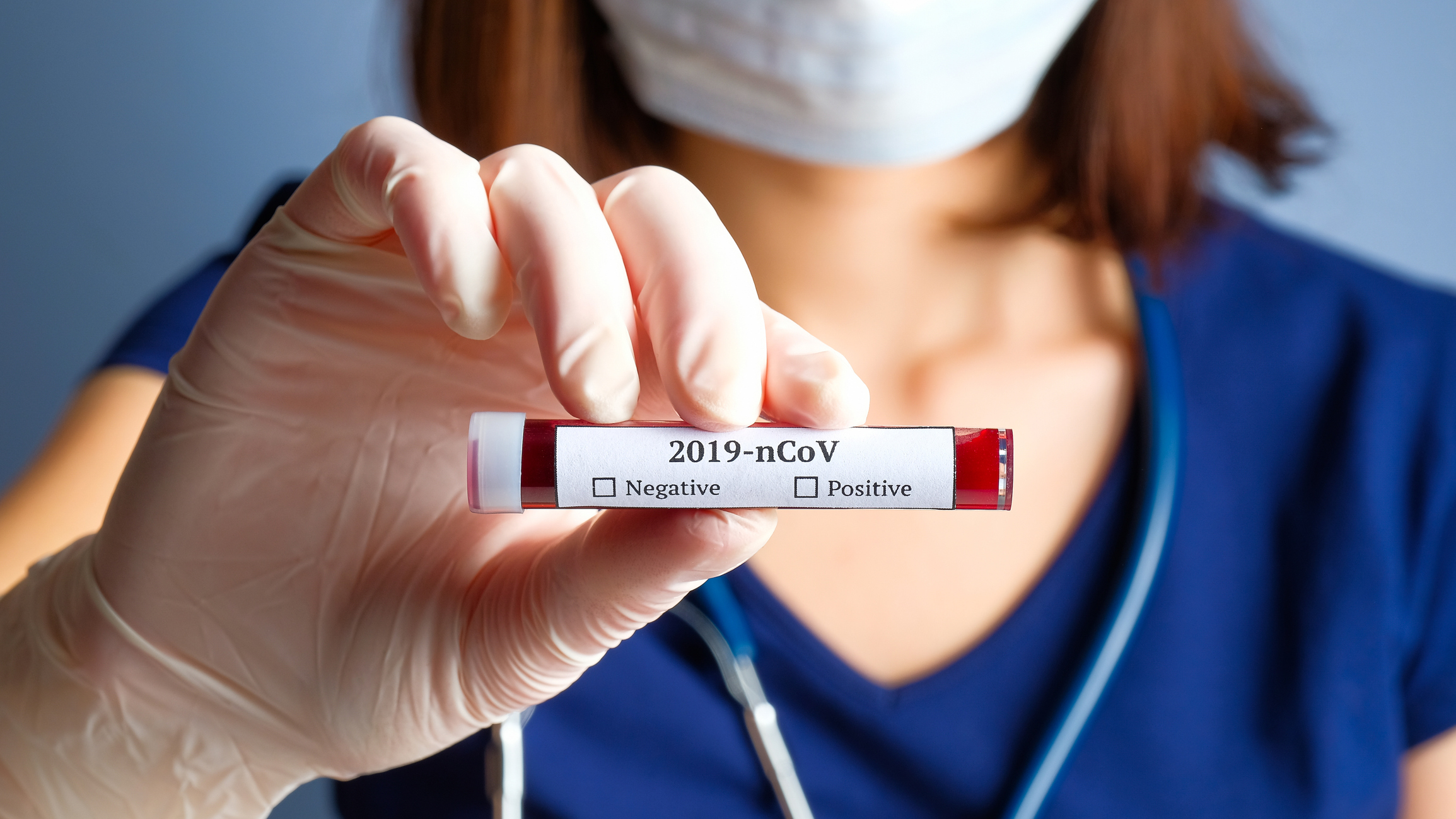 Nurse holding a Covid-19 blood test Nurse holding a Covid-19 blood test