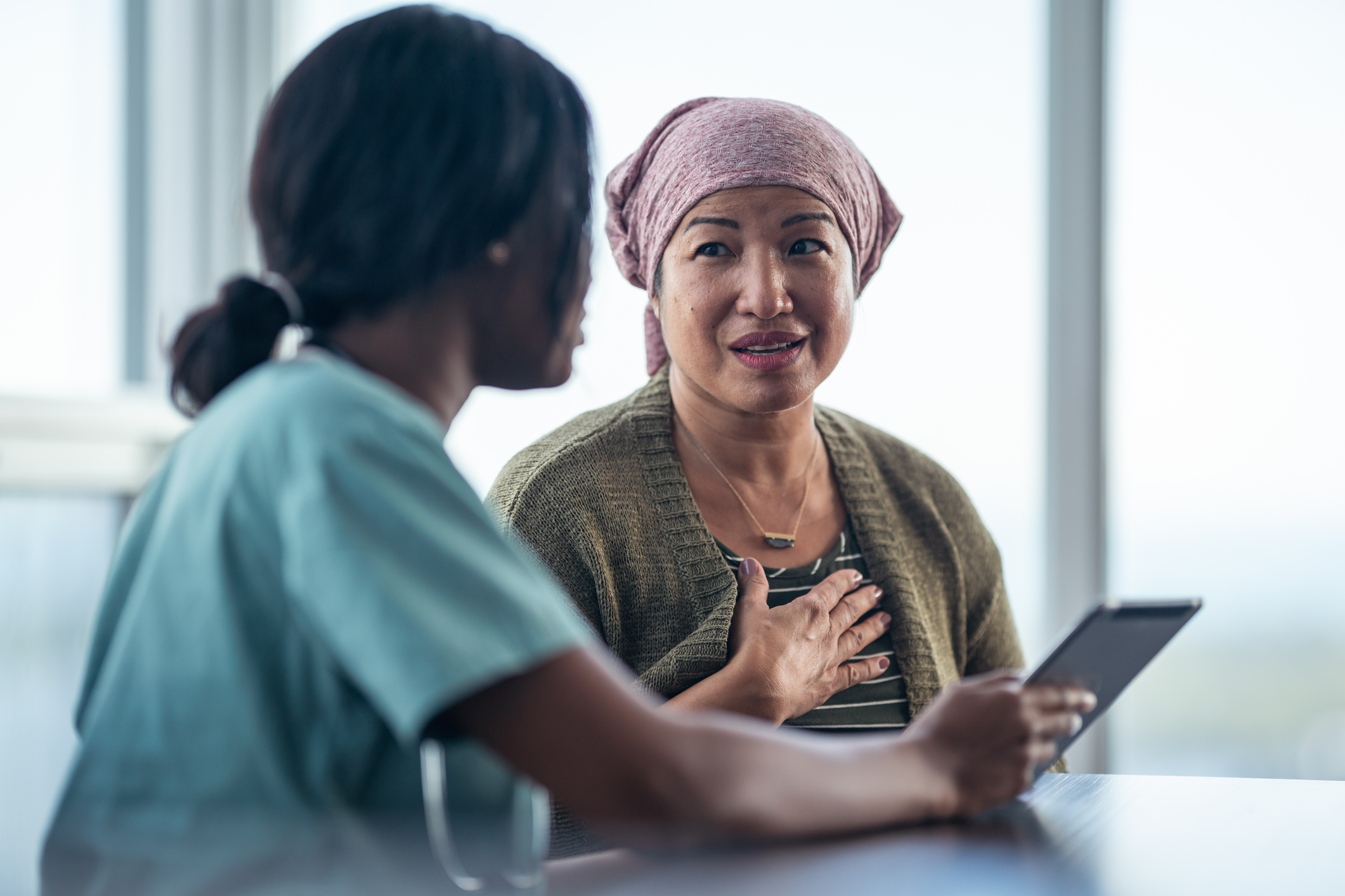 Nurse speaking with a patient of a different nationality Nurse speaking with a patient of a different nationality
