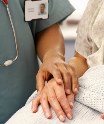 Nurse holding a patient's hand Nurse holding a patient's hand