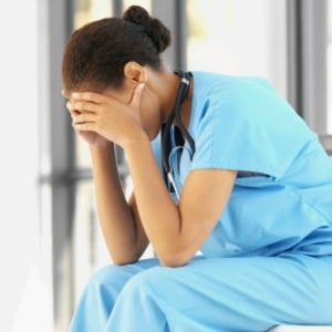 Stressed nurse with her hands on her head Stressed nurse with her hands on her head