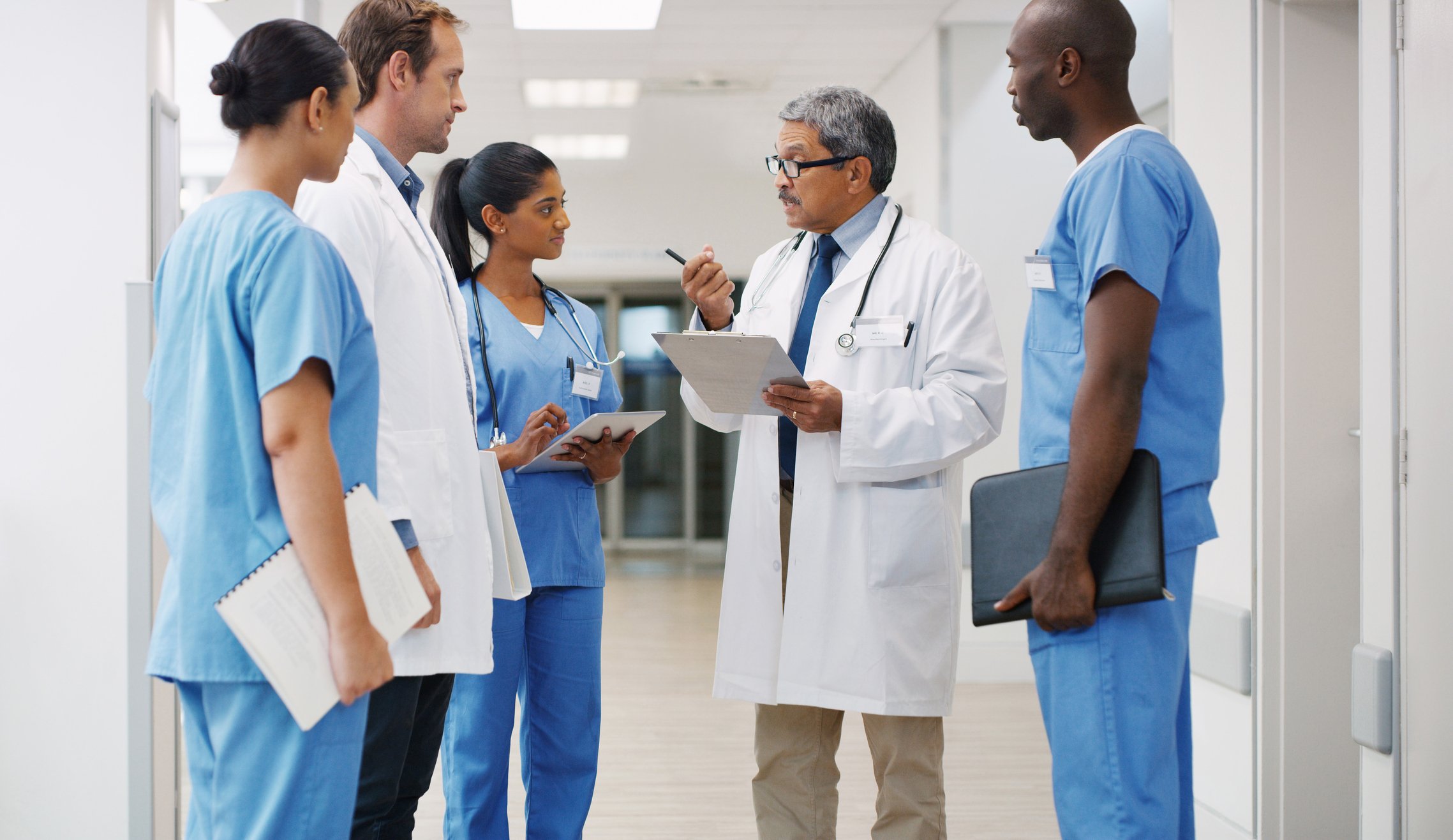 Diverse group of healthcare workers talking Diverse group of healthcare workers talking