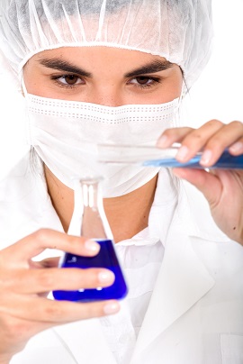 Healthcare worker mixing liquids in a beaker Healthcare worker mixing liquids in a beaker