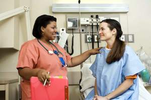 Nurse speaking with a patient Nurse speaking with a patient
