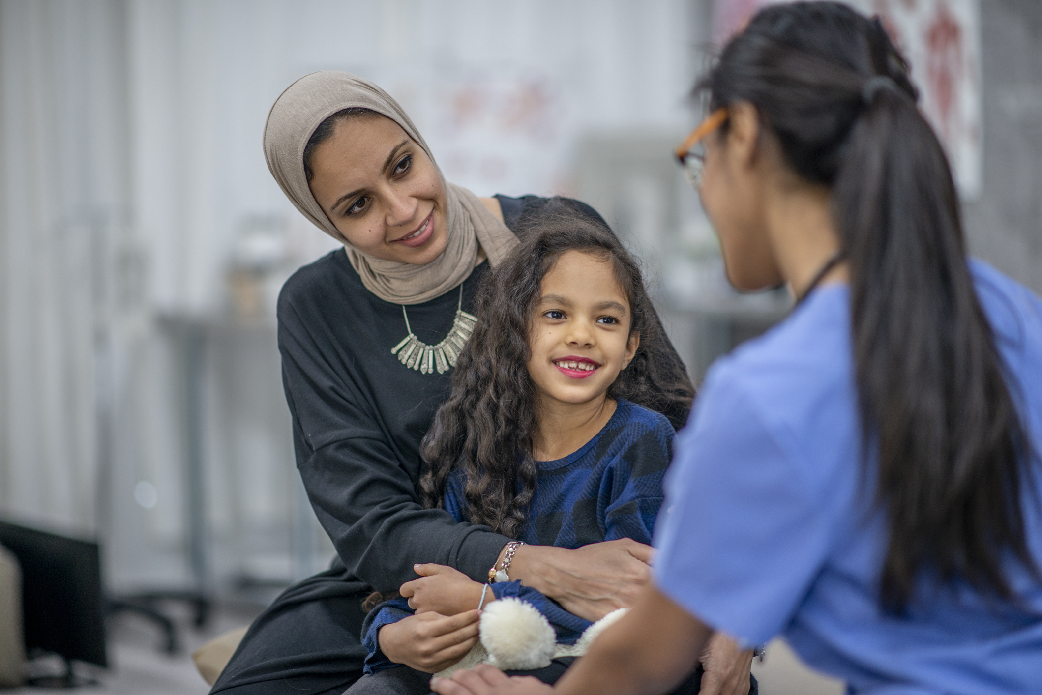 Nurse talking with a mother and daughter Nurse talking with a mother and daughter