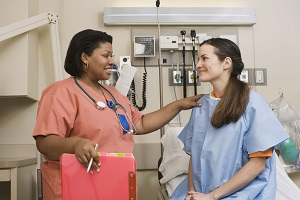 Nurse checking on a patient Nurse checking on a patient