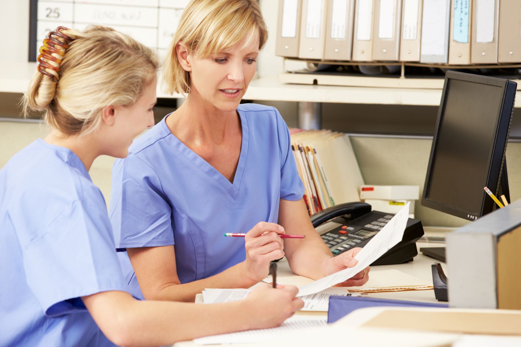 Charge Nurse helping a staff member Charge Nurse helping a staff member
