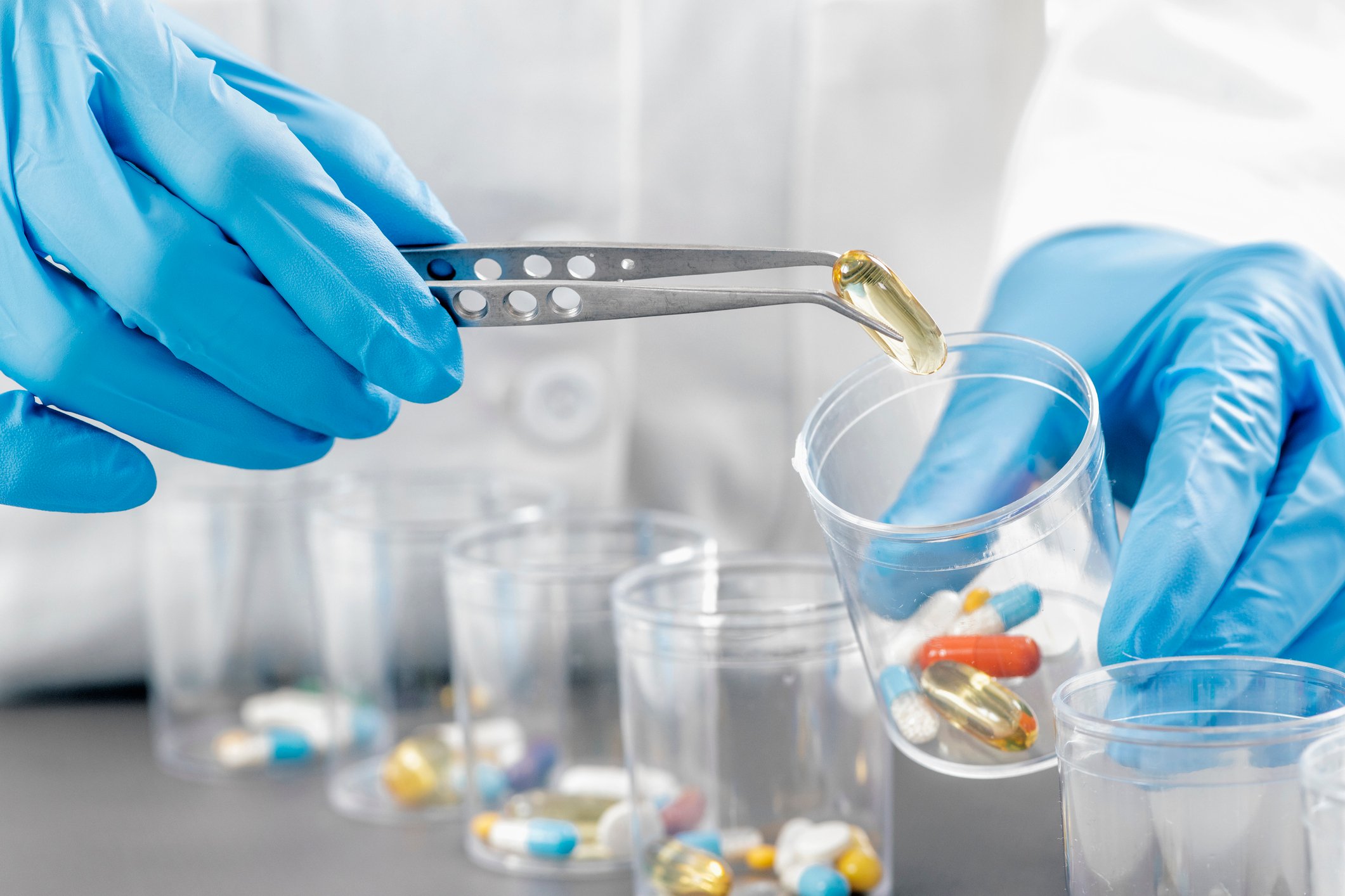 nurse allocates patient medications into tiny cups nurse allocates patient medications into tiny cups