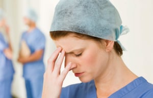 nurse in blue scrubs looking very stressed nurse in blue scrubs looking very stressed