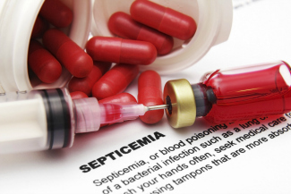 red pills and syringe lay over medical documents red pills and syringe lay over medical documents