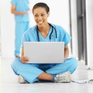 Nurse on her laptop smiling Nurse on her laptop smiling