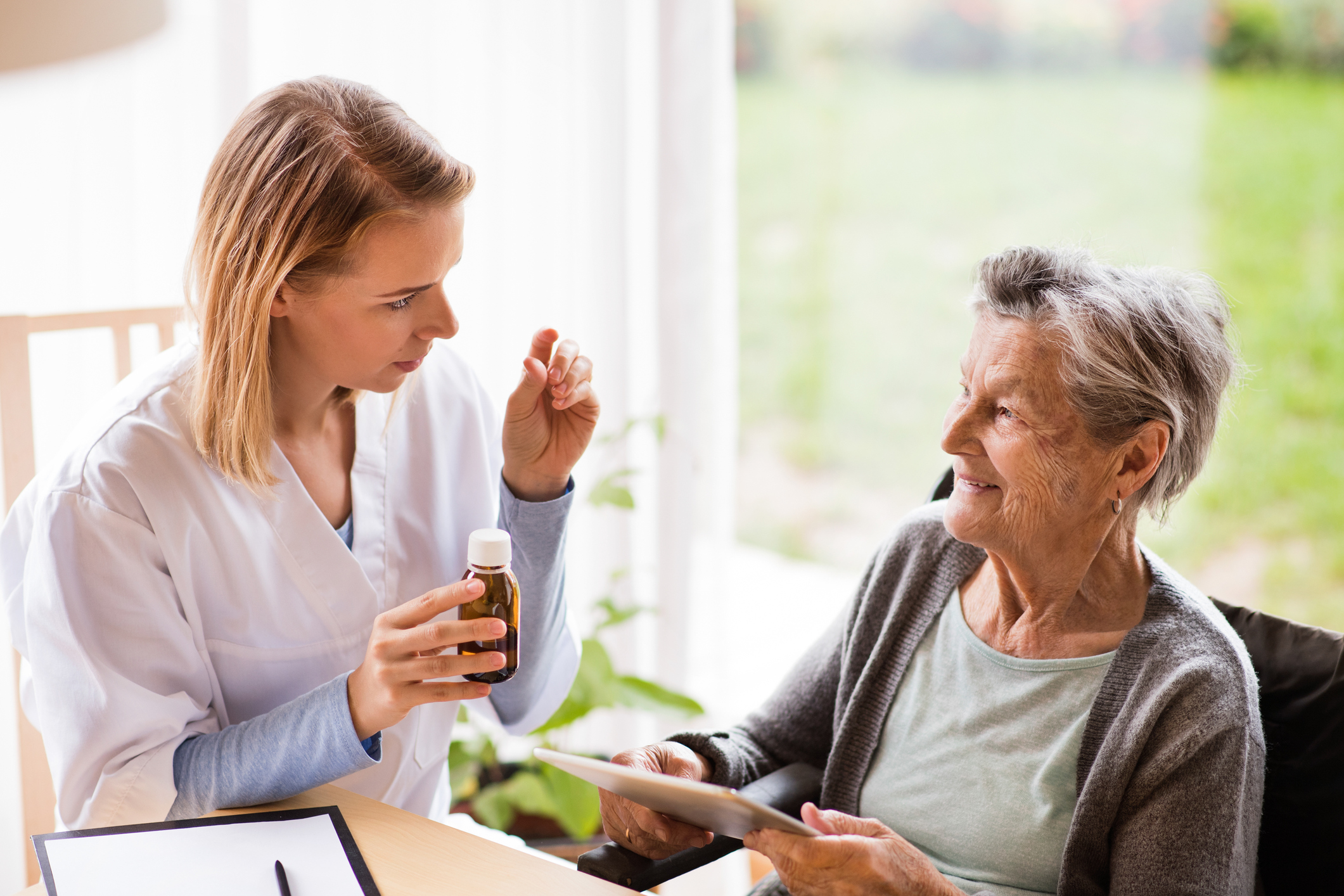 Nurse giving a patient pain medication Nurse giving a patient pain medication