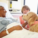 Patient smiling while petting a dog Patient smiling while petting a dog