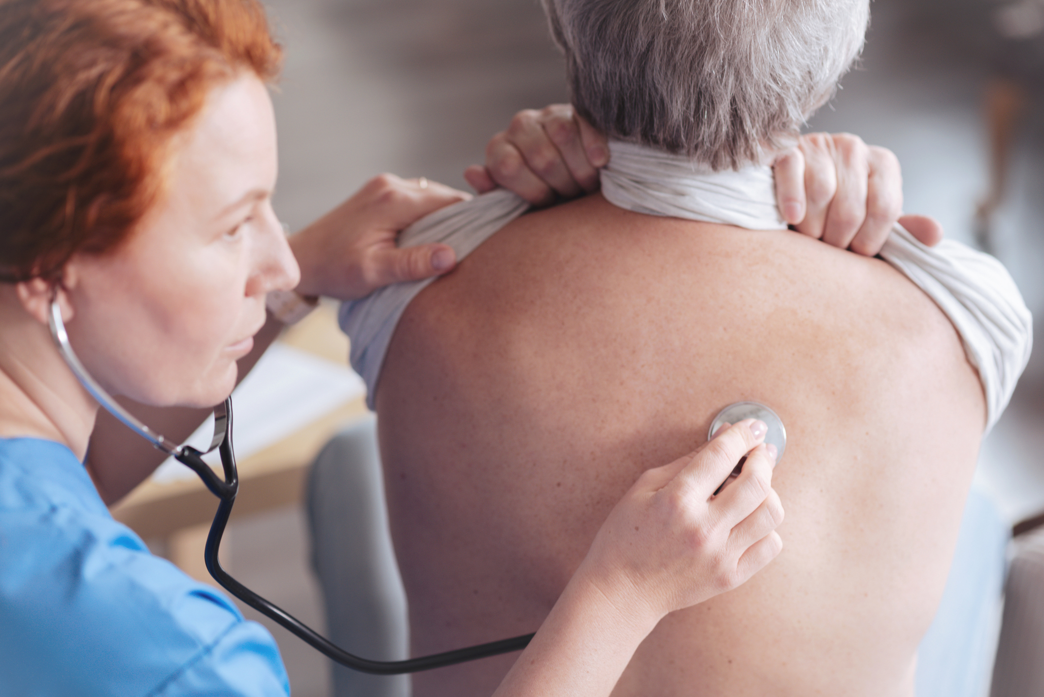 Nurse checking a patient's lungs Nurse checking a patient's lungs