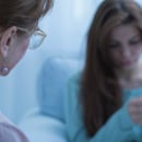 Nurse talking to a patient struggling with mental health Nurse talking to a patient struggling with mental health