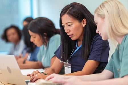 Two women getting their nursing certifications online Two women getting their nursing certifications online