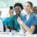 Nurses smiling in a board meeting Nurses smiling in a board meeting